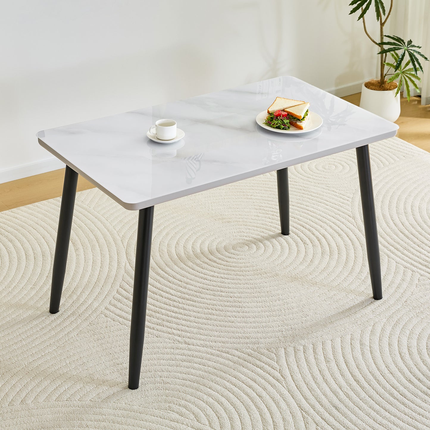 Modern minimalist rectangular dining table, suitable for 4-6 people. Tempered glass countertop+lower MDF board, imitation marble texture, black metal tapered legs. Suitable for minimalist restaurants.